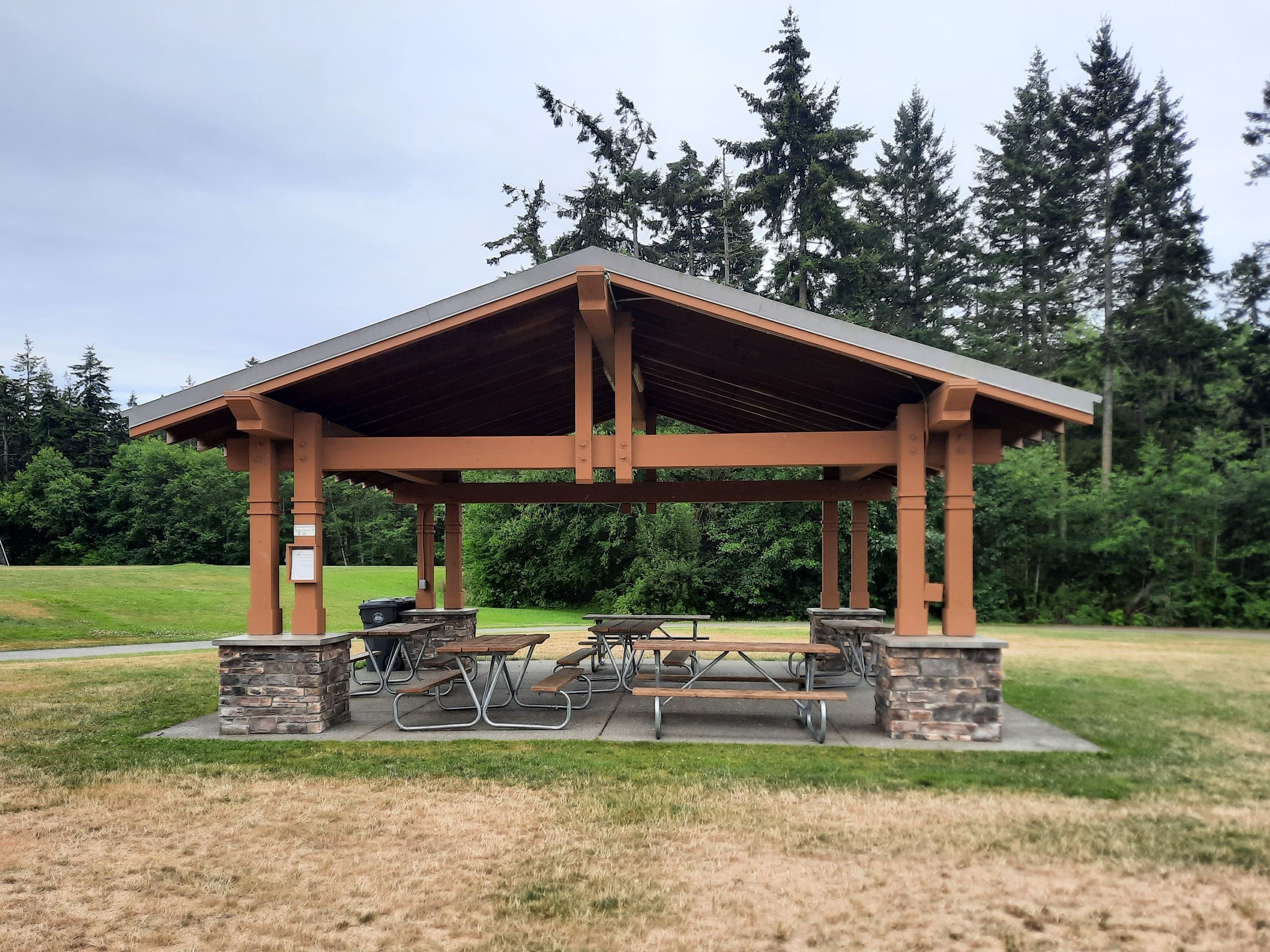 Open-air covered shelter with picnic tables